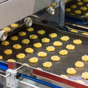 Cookie production line. Running on conveyor belt.